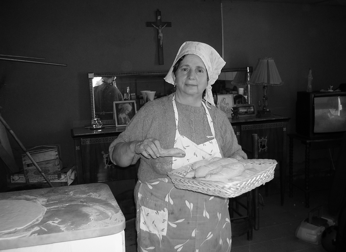 My mother while cooking her weekly bread.