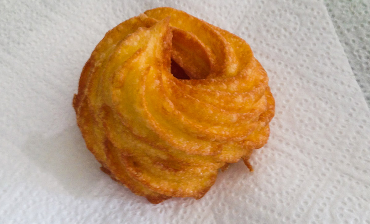 Fried zeppole, cooked and on absorbent food paper. Cooling down.