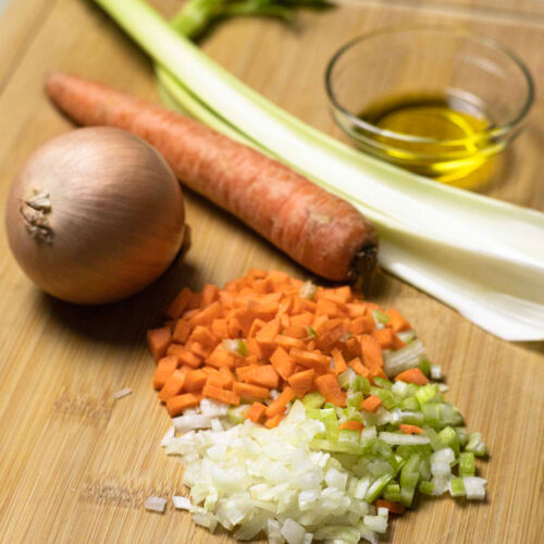 Italian soffritto ready on a wooden cutting board.