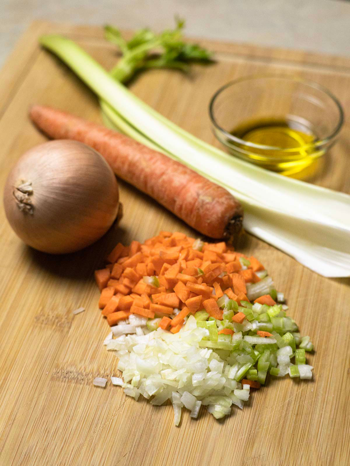 Italian soffritto ready on a wooden cutting board.