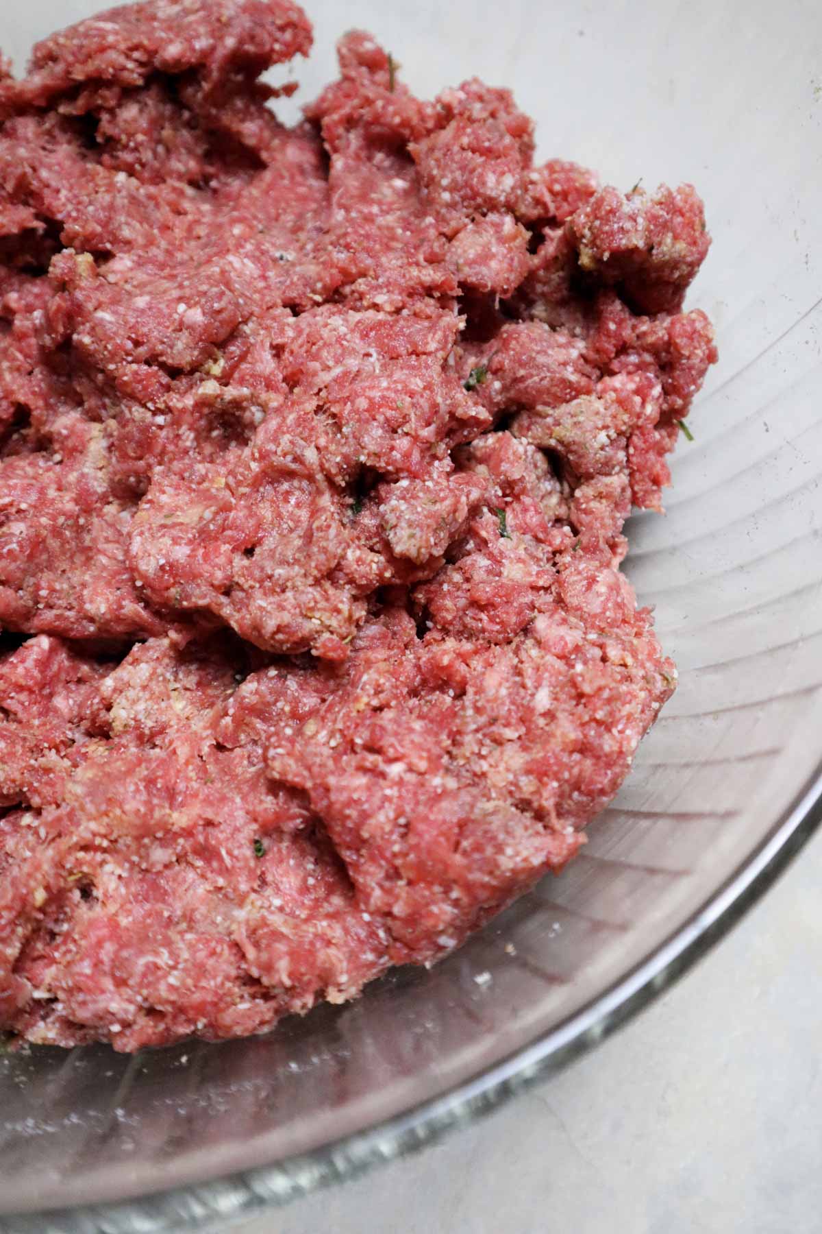 Ground beef mixture with salt, pepper, eggs, breadcrumbs, chopped fresh parsley, Parmigiano Reggiano DOP, and a clove of chopped fresh garlic.