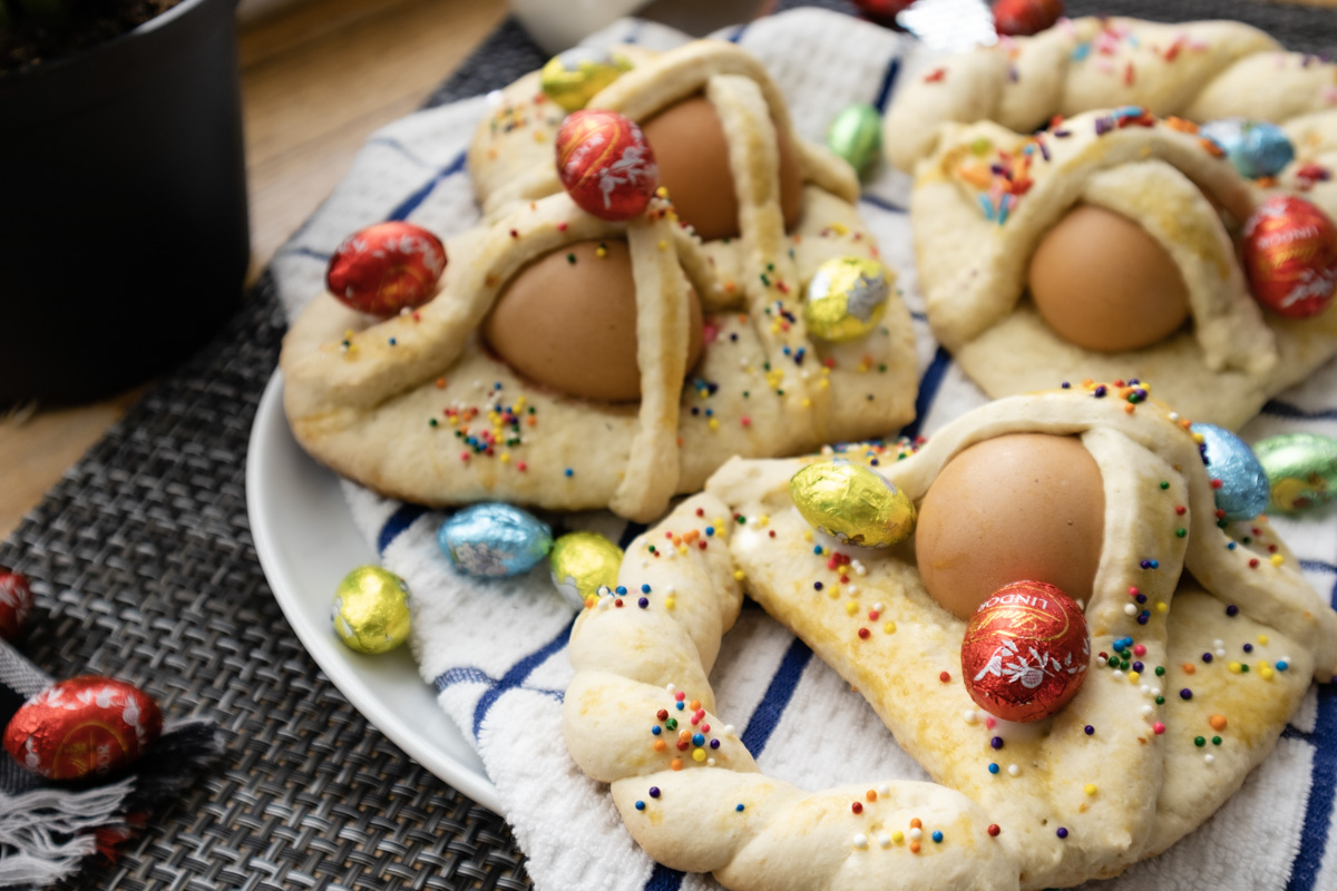 Inside my Italian Kitchen Easter cookies shot decorated with rainbow sprinkles and chocolate eggs.