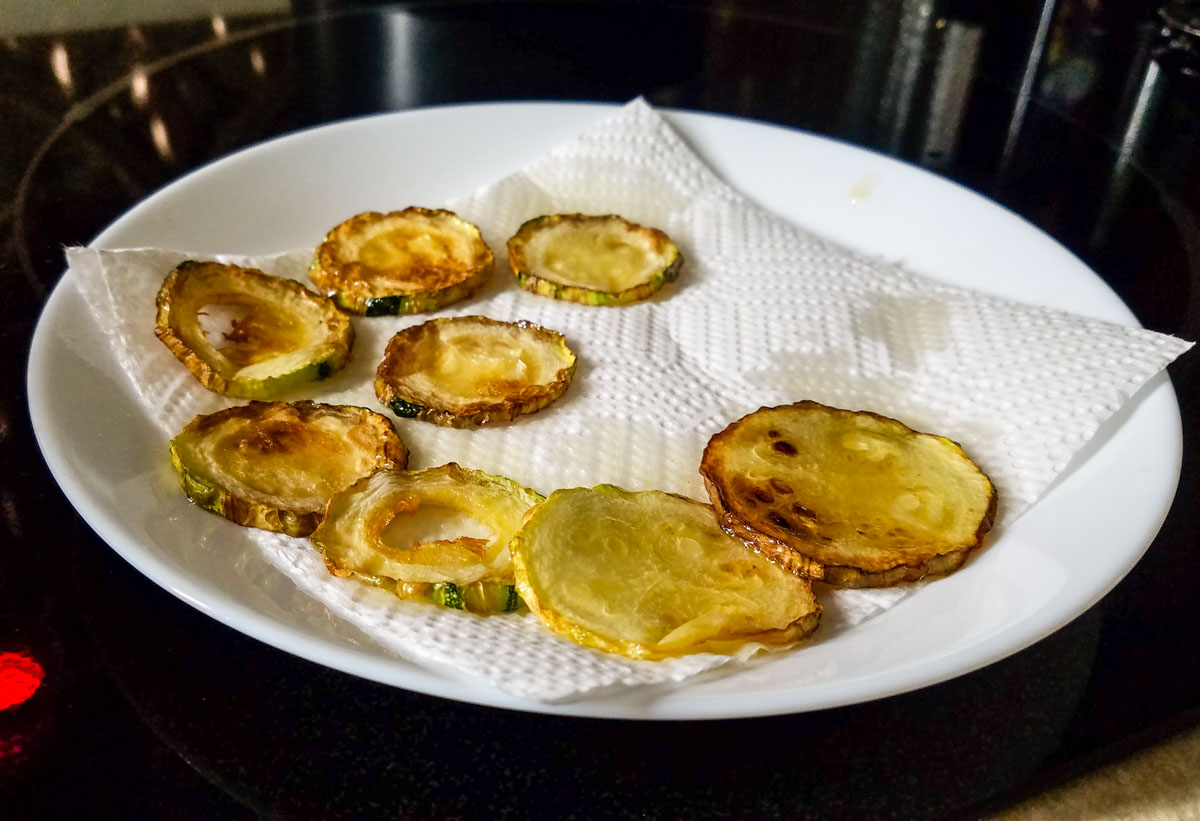 Fried zucchini on a white plate for pasta with fried zucchini.